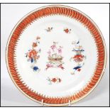 An 18th century Chinese porcelain armorial plate having geometric painted border with tall ship