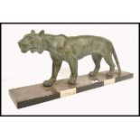 A 1930's Art Deco large verdigris spelter tiger. Raised on a veined marble plinth with black and