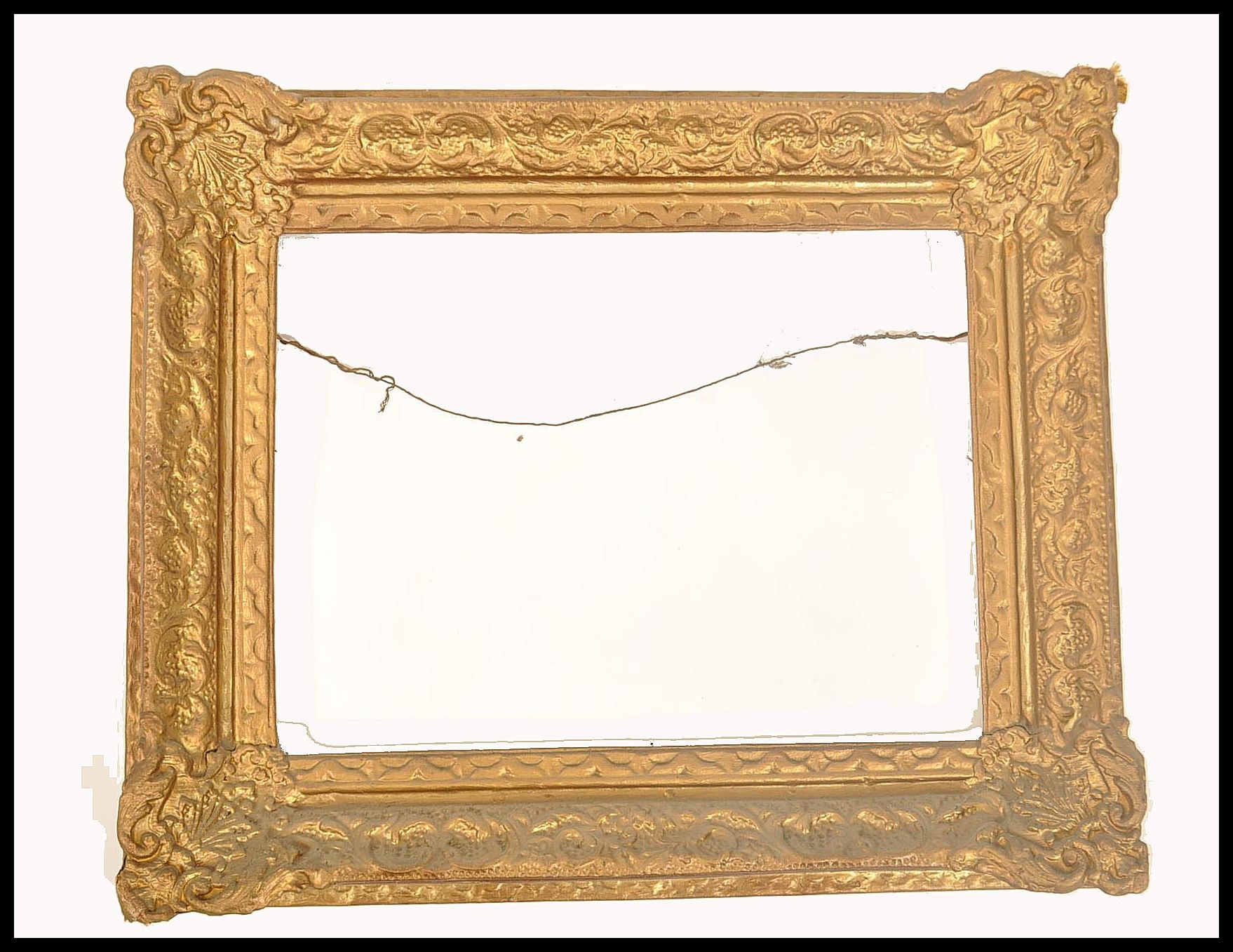 A 19th century good papier mache gilded rococo mirror - picture frame. Of angled cushion form with