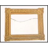 A 19th century good papier mache gilded rococo mirror - picture frame. Of angled cushion form with