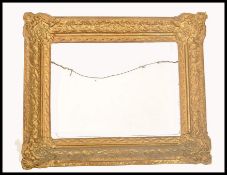 A 19th century good papier mache gilded rococo mirror - picture frame. Of angled cushion form with