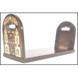 A 19th century Regency Coromandel and brass  metamorphic folding book stand. The arched ends with