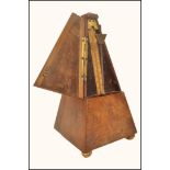 A 19th century French metronome in walnut pyramid shape case, bears brass plaque for Maelzel Paque
