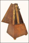 A 19th century French metronome in walnut pyramid shape case, bears brass plaque for Maelzel Paque