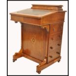 A 19th century VIctorian mahogany inlaid davenport desk. The hinged top with tooled leather