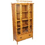 A Victorian Aesthetic movement bamboo upright tall display cabinet. Bamboo supports with stunning