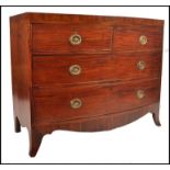 A 19th century mahogany bow front  bachelors chest of drawers being raised on French ' kick legs '