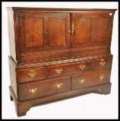 An 18th century oak housekeepers livery cupboard. The beautiful oak with crossbanded mahogany