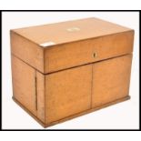 A 19th century Victorian golden oak three decanter Tantalus box having brass monogram to lid. The