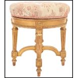 A 19th century French giltwood and gesso revolving piano stool in Louis XVI style. The stuffed