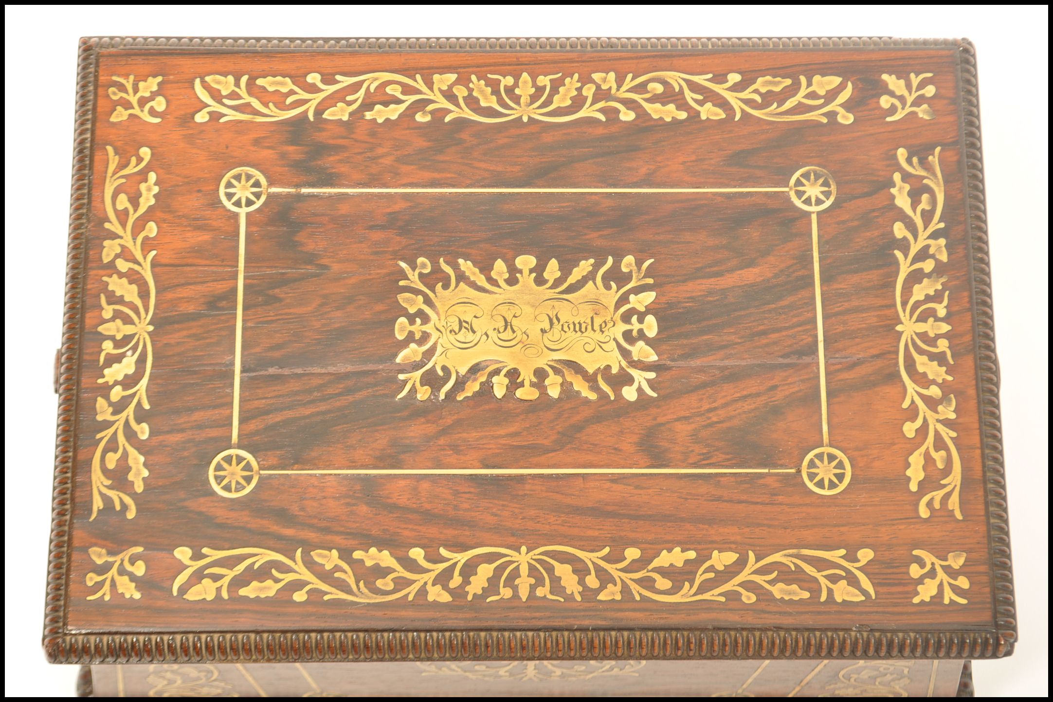 A Regency rosewood brass inlaid work box raised on bun feet with gadrooned edges. Loop handles to - Image 9 of 10