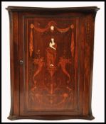 A 19th century rosewood marquetry and bone inlaid hanging corner cabinet. The door with stunning