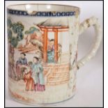 A 19th century Chinese export porcelain mug being decorated with scenes of family and pagoda