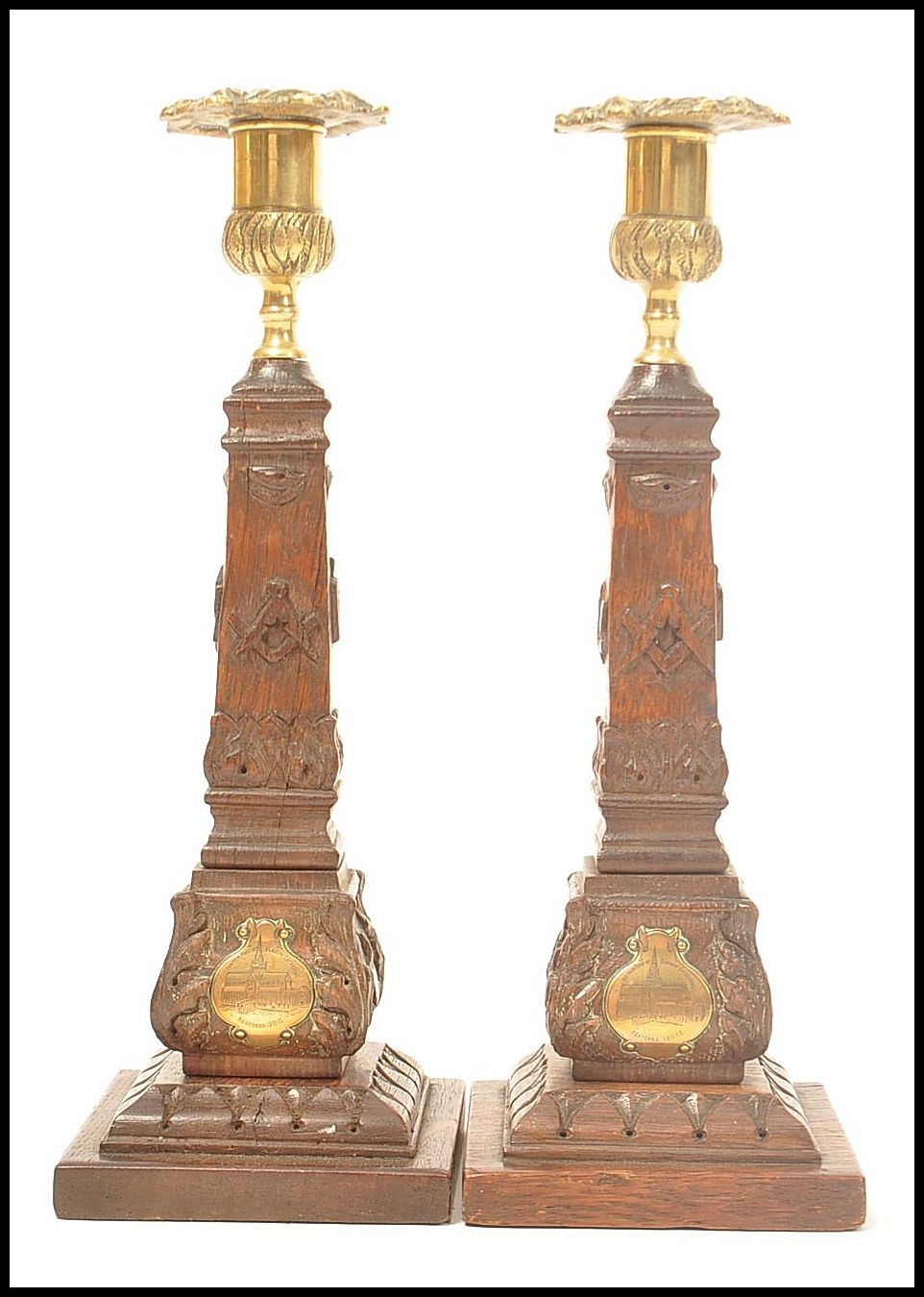 A pair of Masonic carved wooden souvenir candlestick with cast brass sockets, the base of each