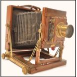 An early 20th century The Victo plate bellows camera having a mahogany case with brass mounts. Brass