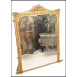 A large 18th / 19th century wall mirror of tall form having stunning gilt plaster frame with