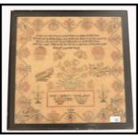 A 19th century needlepoint sampler dated 1843 by Maria Masleys age 9. The sampler panel with