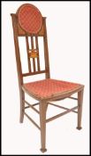 An Edwardian mahogany inlaid investiture chair being raised on tapered legs with stretchers having