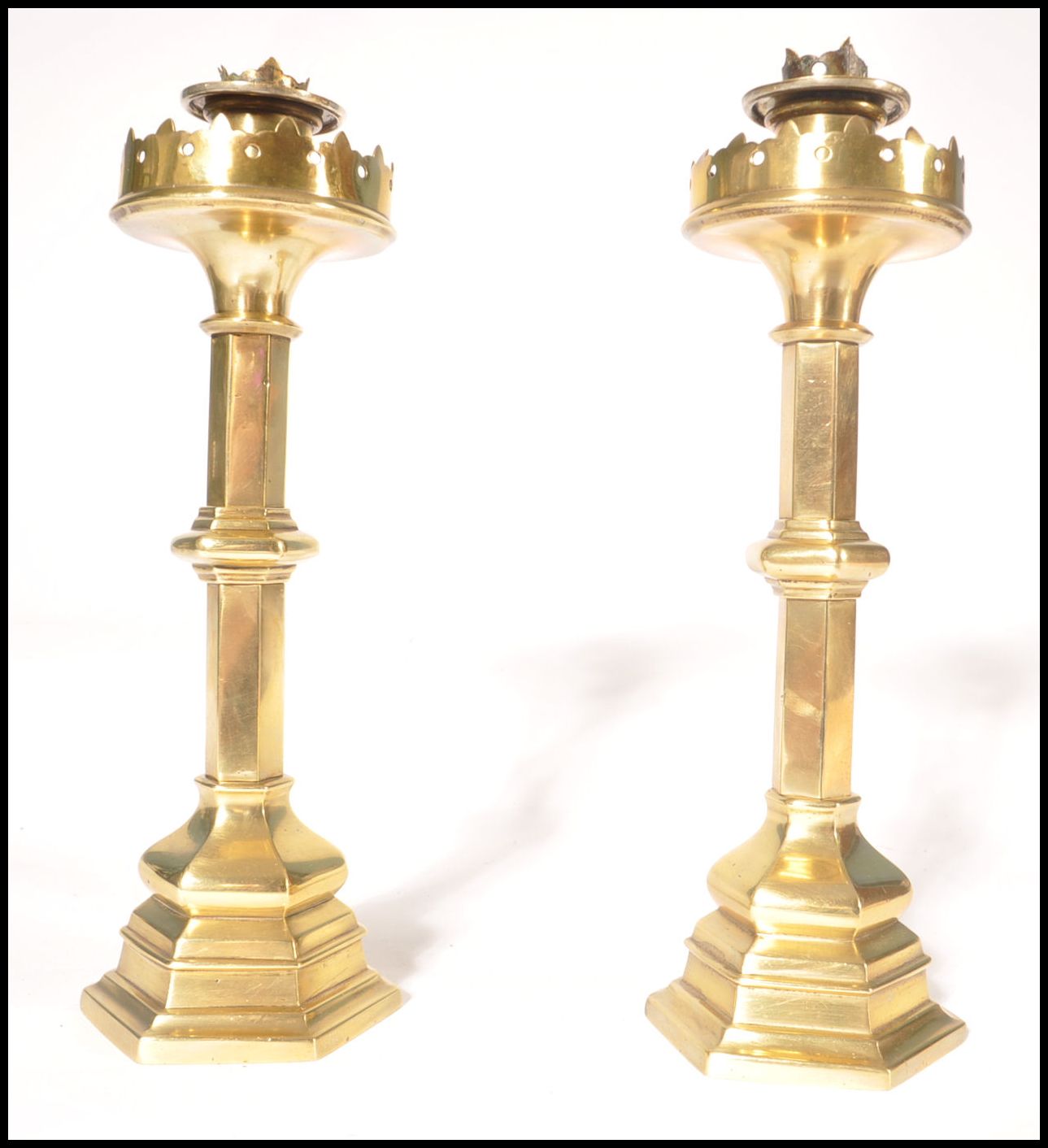 A pair of believed Pugin 19th century Victorian heavy brass candlesticks of hexagonal column form