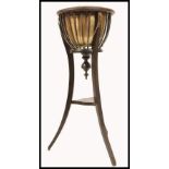 A late 19th century brass and mahogany planter stand / jardiniere. Raised on sabre supports with