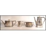 An Elkington & Co 4 piece silver plated tea service being chased with wreath and central monograms