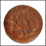 A Chinese Jade roundel seal of mottled brown colour carved with scrolling dragon motif and geometric