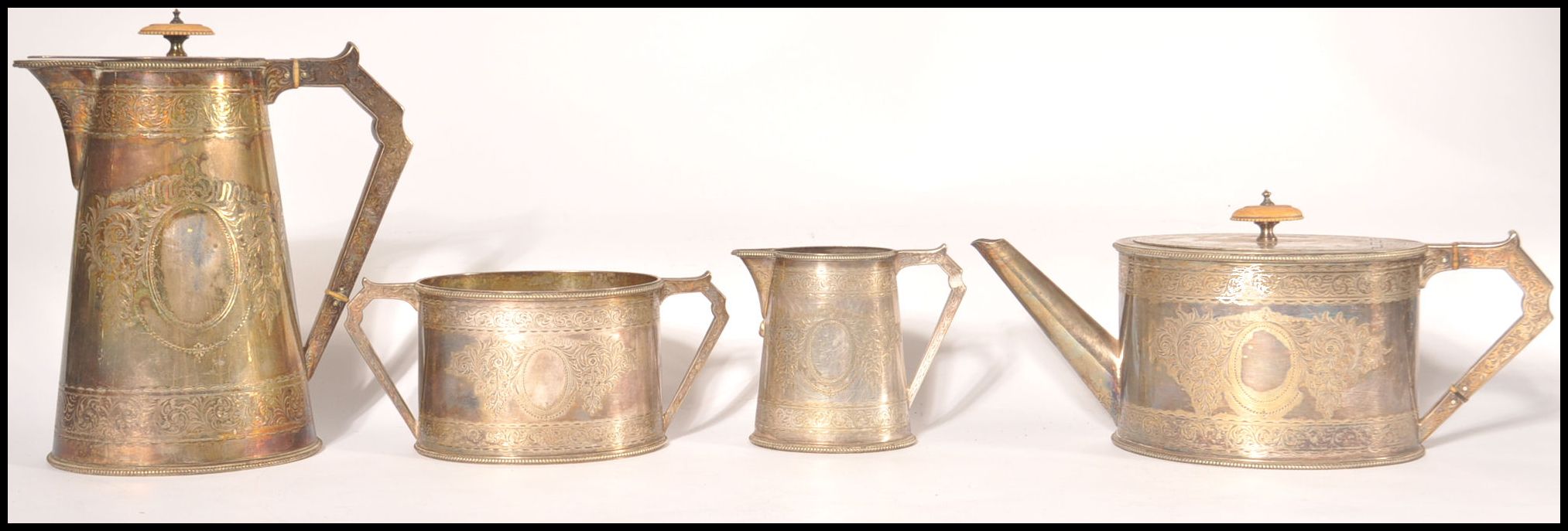 An Elkington & Co 4 piece silver plated tea service being chased with wreath and central plain