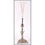 An early 20th century Egyptian revival epergne raised on scrolled and winged tripod feet with