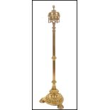 A 19th century brass tall oil lamp standard raised on a trefoil base with pad feet, turned reeded