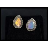 A pair of silver opal and CZ pear shaped earrings