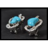 A pair of silver CZ and turquoise set earrings com