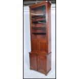 A 19th century mahogany bookcase cupboard of slim