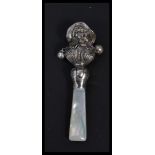 A sterling silver babies rattle in the form of a l