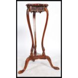 A vintage 20th century mahogany torchere plant sta