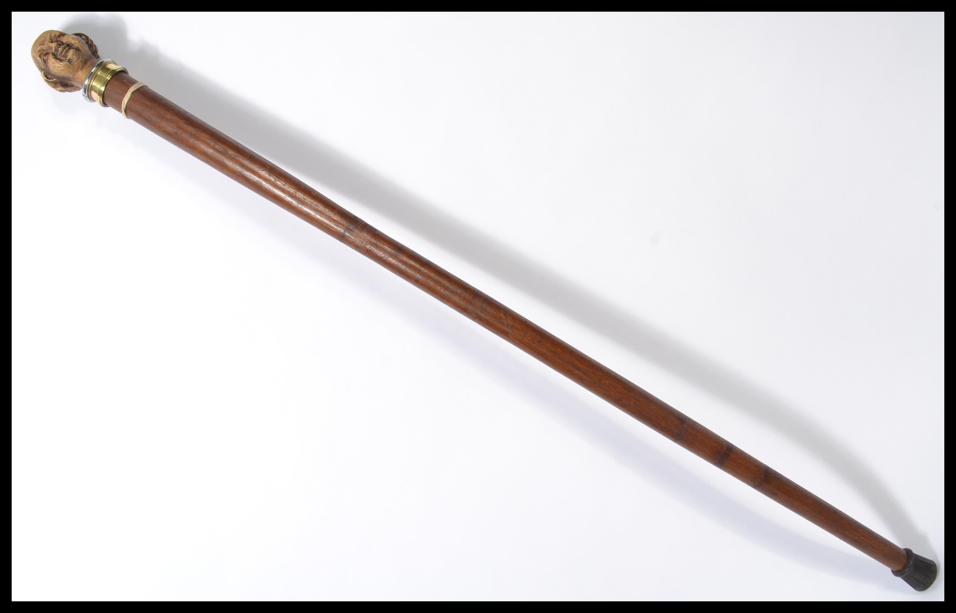 A vintage 20th century walking stick cane having a