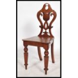 A 19th century mahogany armorial hall chair, the s