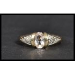 A hallmarked 9 carat gold ring with an oval clear