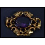 A yellow metal substantial amethyst brooch with ce