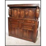 A 1930's oak court cupboard with upper cupboard, t