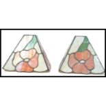 A pair of 20th Century Tiffany style stained lead glass lamp / ceiling  shades, each panel decorated