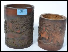 Two 19th century Chinese bamboo brush pots one decorated with men riding an ox and one decorated