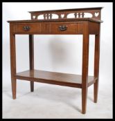 An early 20th Century Art Nouveau hall / console table with two drawers with fitted brass swag
