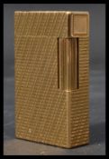 A vintage 20th century French gilt bronze Dupont lighter with serial number to base. Measures 6 cm