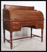 A good 20th century solid mahogany tambour top roll front carlton house desk. Raised on turned