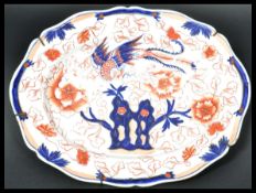 A 19th century Chinese Imari pattern charger of scalloped form depicting ho ho birds with flowers