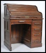 An oak roll top desk circa 1930's, with tambour shutter enclosing fitted drawers and pigeon holes,