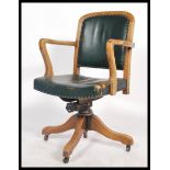 A vintage early 20th century industrial 1930's swivel chair raised on a quadruped swivel base with