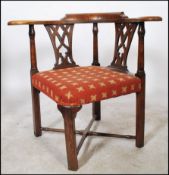 A 19th century Georgian country elm and oak corner chair having cross stretchers with lattice