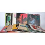 A collection of long play LP vinyl record albums featuring many different artists and genres to