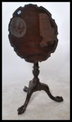 A 19th century mahogany tripod tilt top wine table raised on carved claw and ball feet with